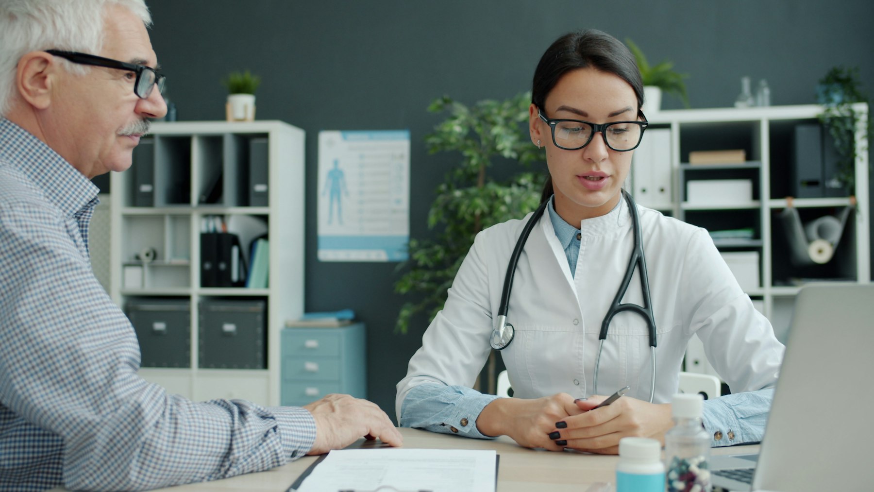 A physician reviewing health information with an older patient