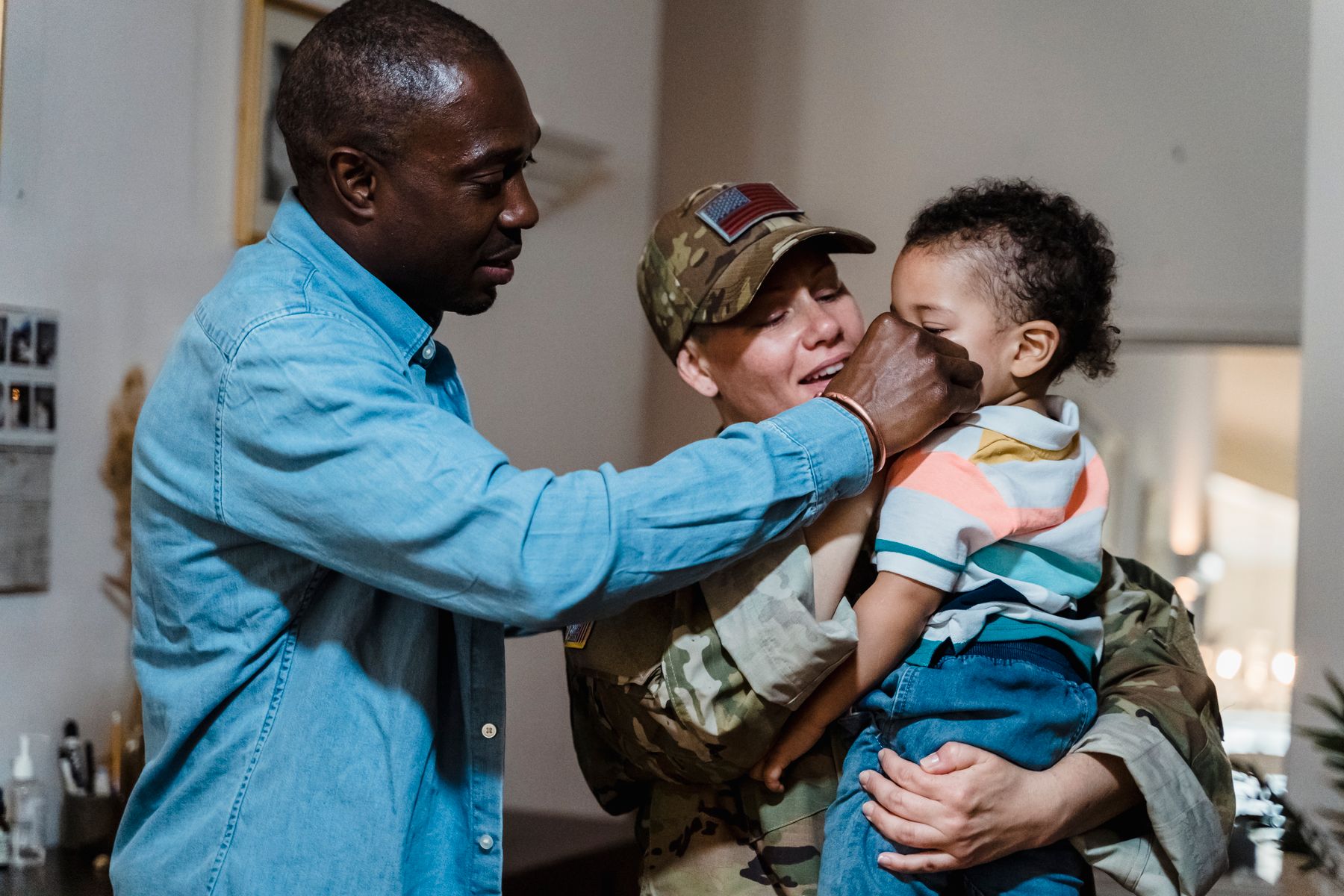 A smiling family greeting each other at home